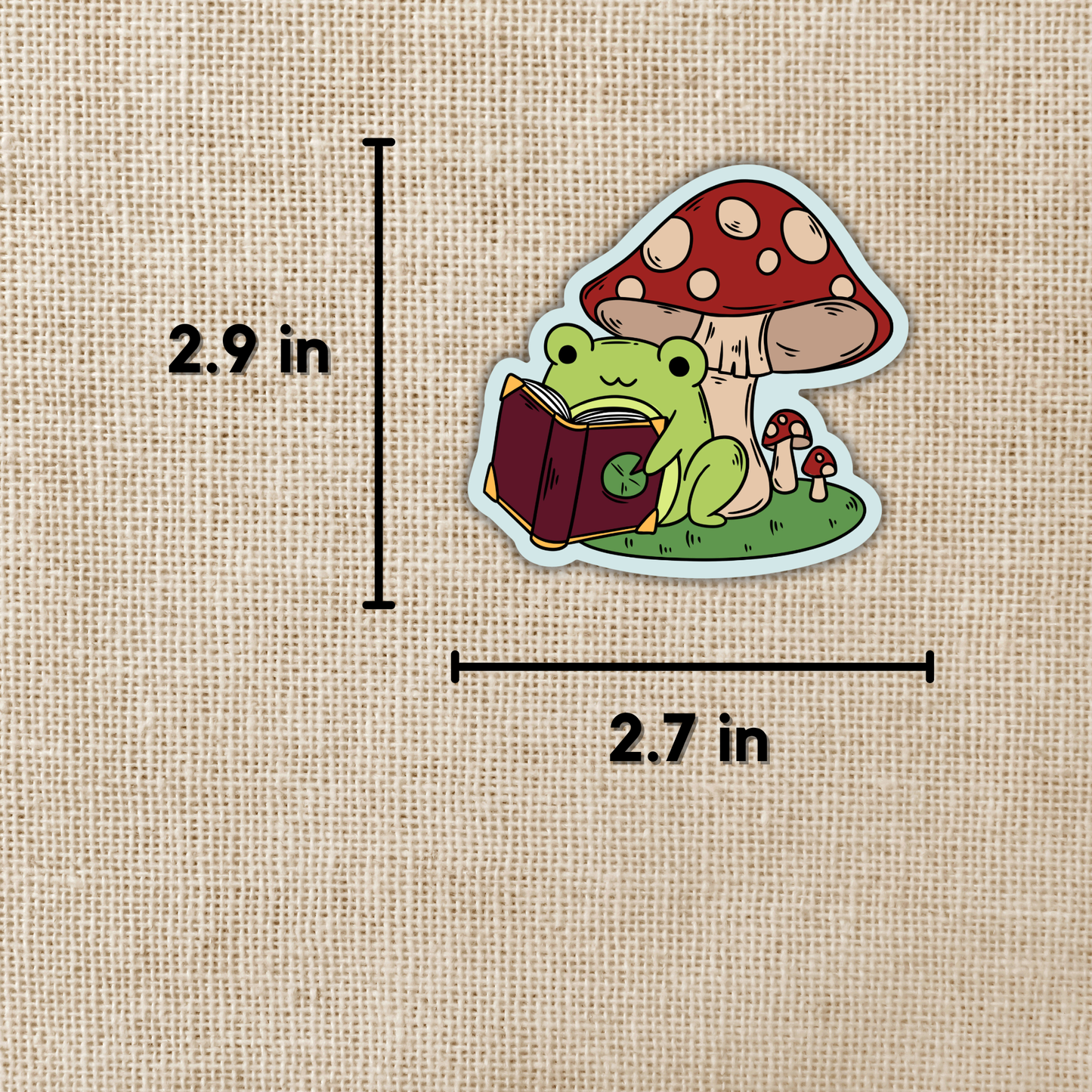 Kingdom of Threads - Frog Reading Under Toadstool Sticker
