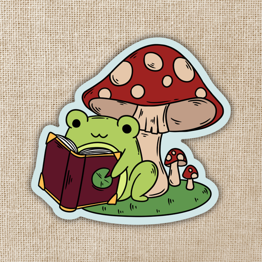 Kingdom of Threads - Frog Reading Under Toadstool Sticker